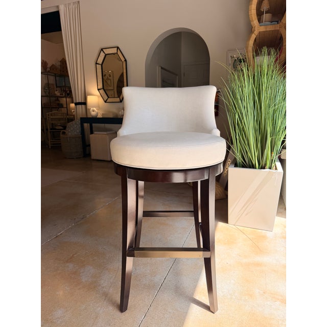 Elevate your space with this contemporary bar stool, featuring a warm ivory leather seat paired with a rich dark wood...