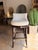 Elevate your space with this contemporary bar stool, featuring a warm ivory leather seat paired with a rich dark wood...