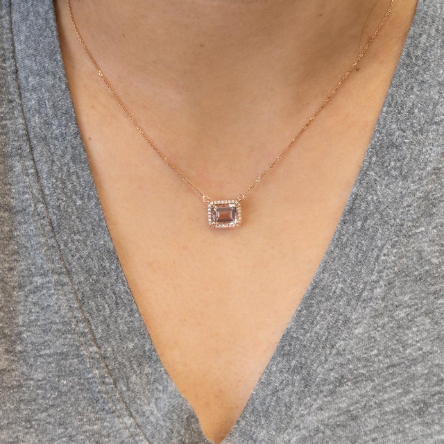 A luminous natural morganite centerpiece, framed by a sparkling halo of genuine diamonds for timeless elegance. Crafted in...