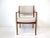 A very well crafted solid teak wood occasional chair with a mid toned cream linen upholstery having flared arms for...