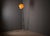 A distinctive vintage floor lamp designed by josef hůrka for napako, featuring a slender metal frame, an elevated conical...