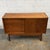 This Danish teak low sideboard has a smart, understated design with a very useful mix of storage. One side is fitted with...