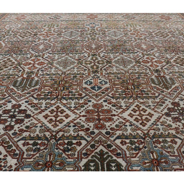 Measures: 7'10 x 10'9 Antique Persian Joshegan Rug in Ivory Background With Blue, Green, & Copper. Keivan Woven Arts/...