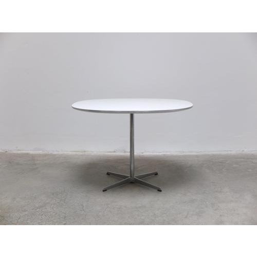 Compact ‘Super-Circular’ dining table designed by Piet Hein & Bruno Mathsson in 1968. This example features a white...
