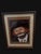The vintage framed print painting by artist Jon Helland is a unique and collectible piece featuring a portrait of a clown...