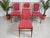 Transform your dining space with this exquisite set of four Mid Century Alfred Cox vintage dining chair dating from the...