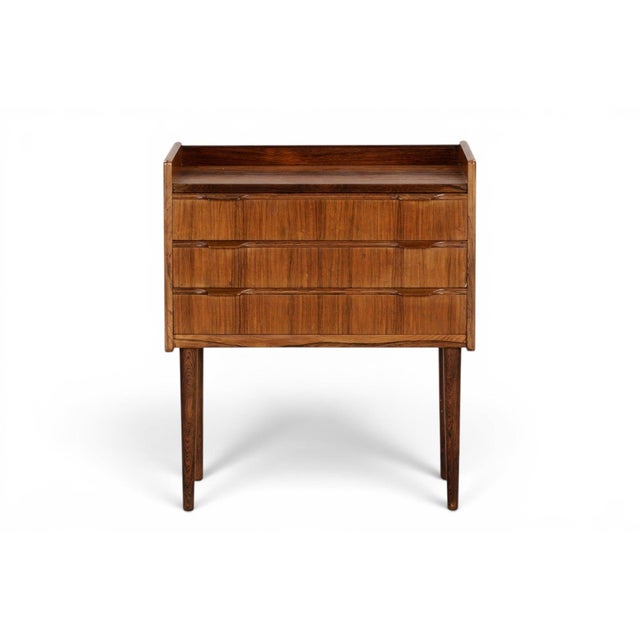 This small three drawer chest brings warm rosewood grain and compact Danish proportions to any bedroom or entryway. Three...