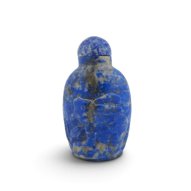 Antique Chinese snuff bottle in deep blue Lapis Lazuli showcasing characteristic white calcite matrix streaks and...