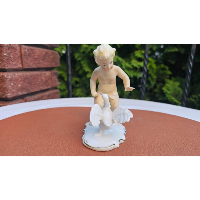 Porcelain figurine, boy with a goose, Schaubach Kunst, 1950s–1960s, dimensions: height 14.5 cm, width 11.7 cm, depth 7.5 cm.