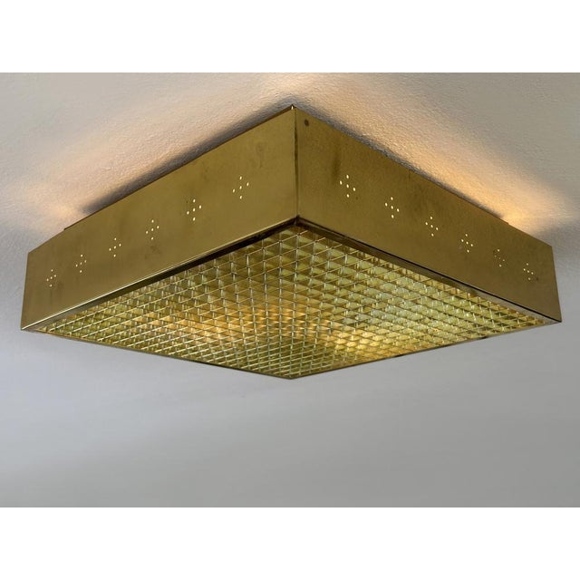 Rare, elegant and highly decorative mid-century modern square ceiling lamp or flush mount with perforated brass frame and...