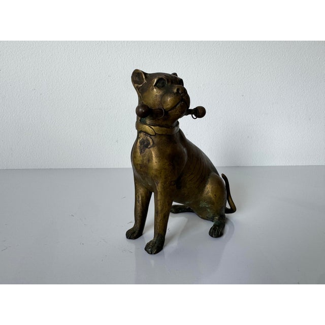 Striking vintage solid brass dog figurine depicting a seated bulldog or mastiff, beautifully sculpted with expressive...