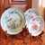 An assembled group of three different designs on celadon porcelain, featuring a bird, butterflies and peonies. A rare...