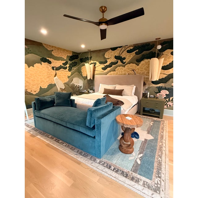The daybed features a contemporary silhouette with clean lines, squared arm panels that wrap partially around the back,...