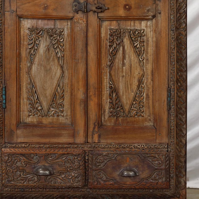 Antique Anglo-Indian carved teakwood armoire, traditionally known as an almirah, once used throughout India for storing...