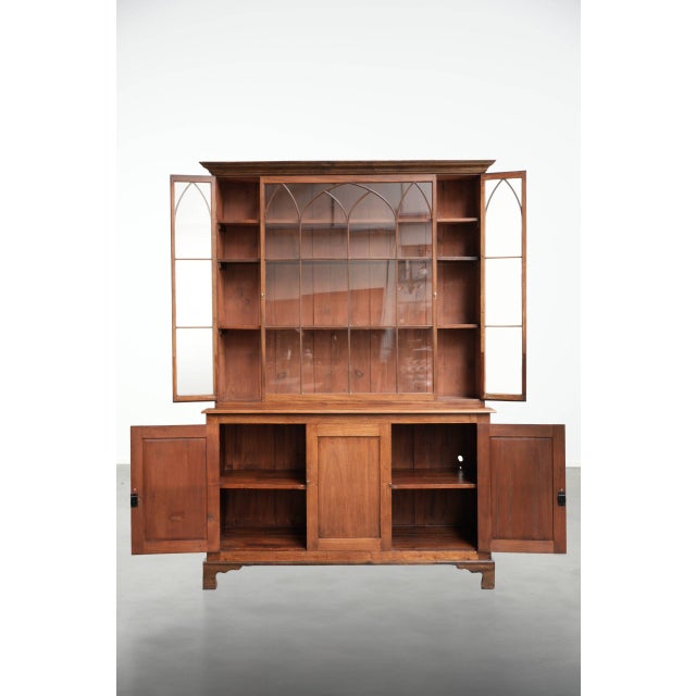 This antique English sideboard in the Gothic style features elegant curved wooden details and a beautiful deep color. The...