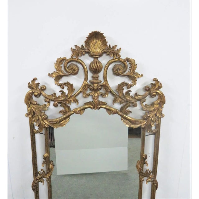 Late 19th century carved giltwood mirror featuring shell crest with leaves and scrolls carved throughout. Made in the...