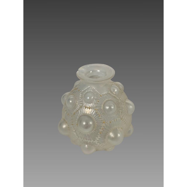 Vase signed René Lalique (1860-1945), "Sunflower" model, 1927. "Sunflower" model vase in slightly opalescent white pressed...