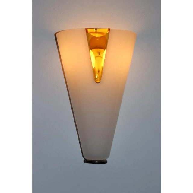 Murano Rare Wall Lamp, Hand Blown Milky White Glass and Transparent Amber Insert. Mounting in white lacquered metal and...