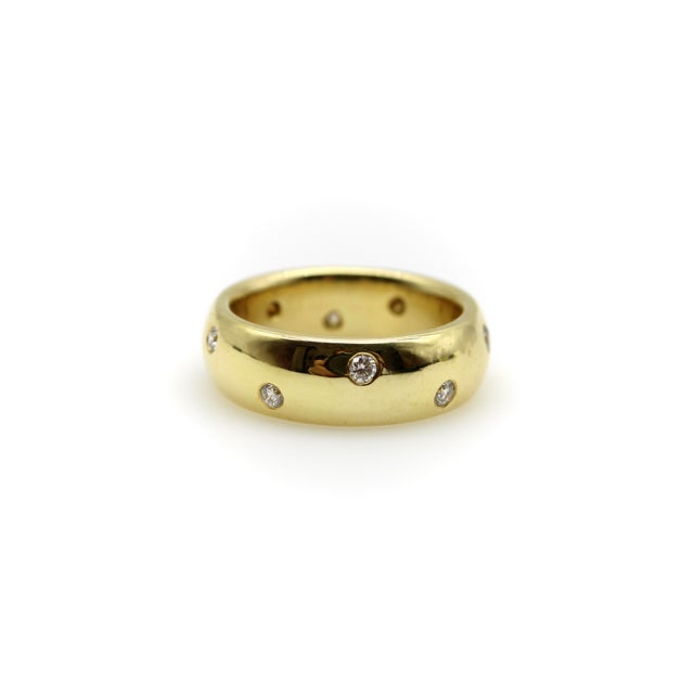 This striking 18k gold band has lots of wonderful features, including ten flush mount round brilliant diamonds...