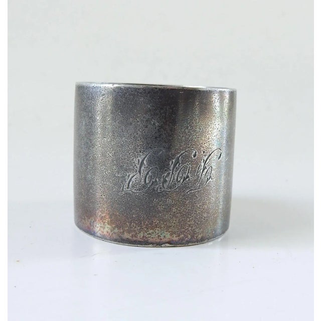 Antique circa 1890's silverplate napkin ring. High relief hand holding flowers, monomgram FPP. Unmarked, dark overall...
