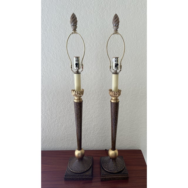 Two matched tall candlestick style neoclassic lamps with painted faux marble on elegant tapered stems and gold colored...