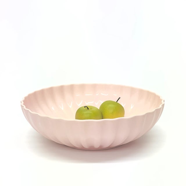 This is a beautiful mid-century blush-pink ceramic bowl with fluted detailing. Height: 4" Width: 14"
