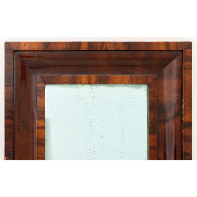 American Flame Mahogany Framed Mirror, circa 1900, with blue glass mirror. Mirror plate: 19.5" H x 11.5" W; frame: 28.75"...