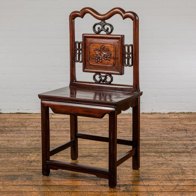 A late Qing Dynasty period rosewood side chair with carved splat adorned with grapevine motif. This late Qing Dynasty...