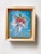 This artwork features a graceful figure emerging from a vibrant fuchsia flower, blending elements of nature and fantasy....