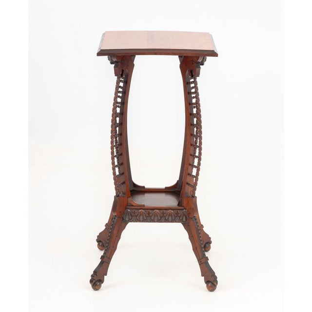 Aesthetic Movement Mahogany Side Table, with square top above carved mask head aprons on pierced spindle curved legs...