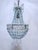 This is a beaded empire style chandelier with blue and clear beads. It has one Edison based socket that can use either a...