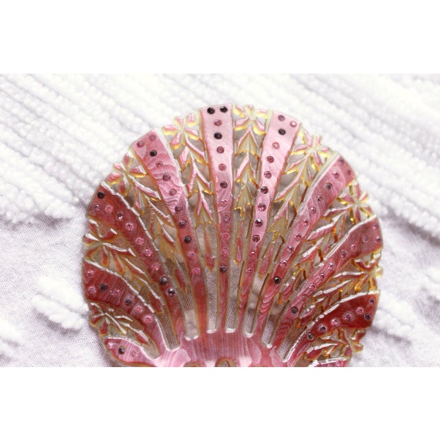 A lovely rhinestone and celluloid comb in the shape of a seashell. Pink and Amber in color. Antique in the Art Deco style...