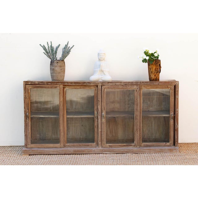 This display cabinet offers a serene and airy take on traditional Farmhouse Colonial cabinetry. Measuring 72 inches in...