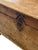 This late 1800’s antique wooden chest and storage trunk, crafted from aged pine with hand-carved details and iron...