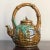 Offering a beautiful early 20th century Chinese majolica sancai glazed teapot. With exquisite detail, the pouch-shaped...