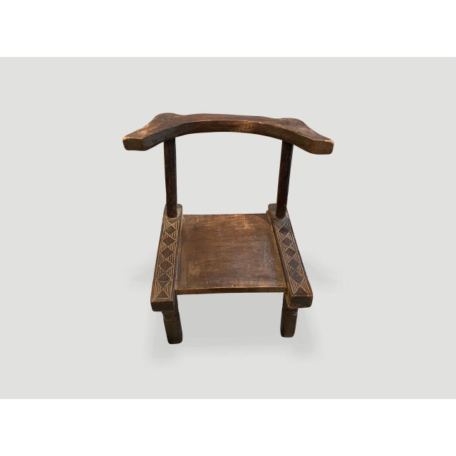 Hand carved wooden chair from the Ivory Coast of Africa. This can also be used as a low side table. A piece of art. This...