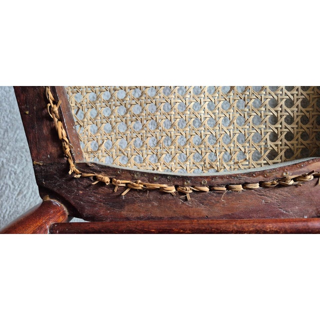 Vintage late 19th, early 20th century Victorian Style Ladder Back Walnut chair with woven cane seat. The chair is...