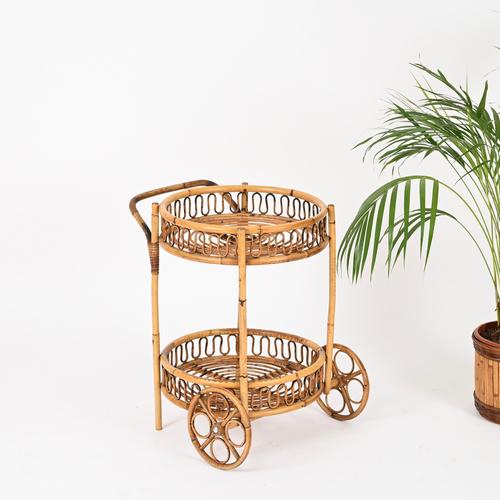 Stunning French Riviera style round serving bar cart entirely crafted in bamboo, curved rattan, and hand-woven wicker....