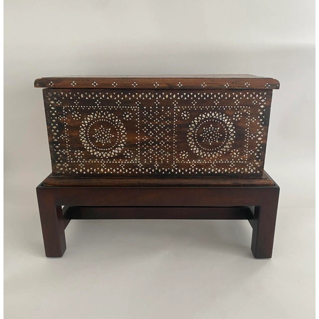 Wood carved chest with mother-of-pearl inlay dating to early 1900s Mindanao sits in a newer custom made wood stand. The...