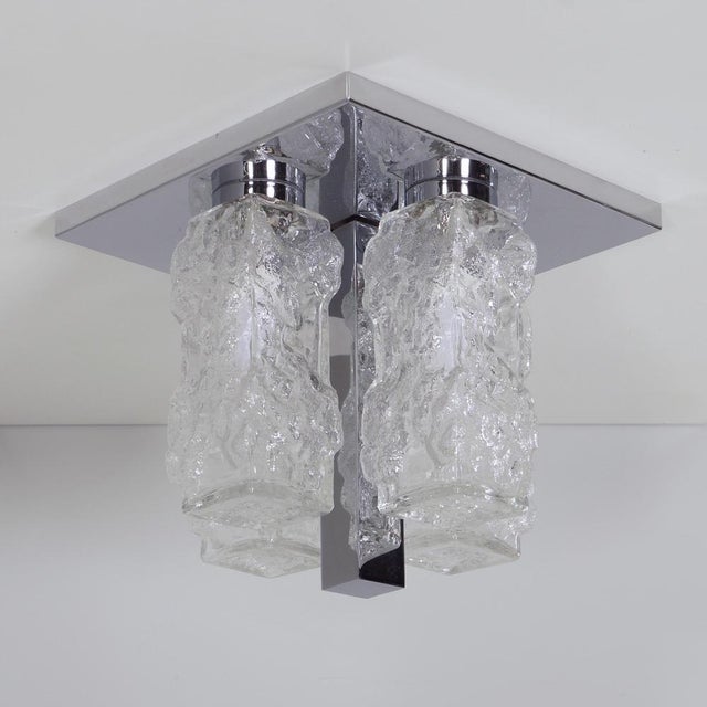 Hillebrand ceiling light in pressed glass from the 1970s with a brutalist and timeless appearance. The square chrome...