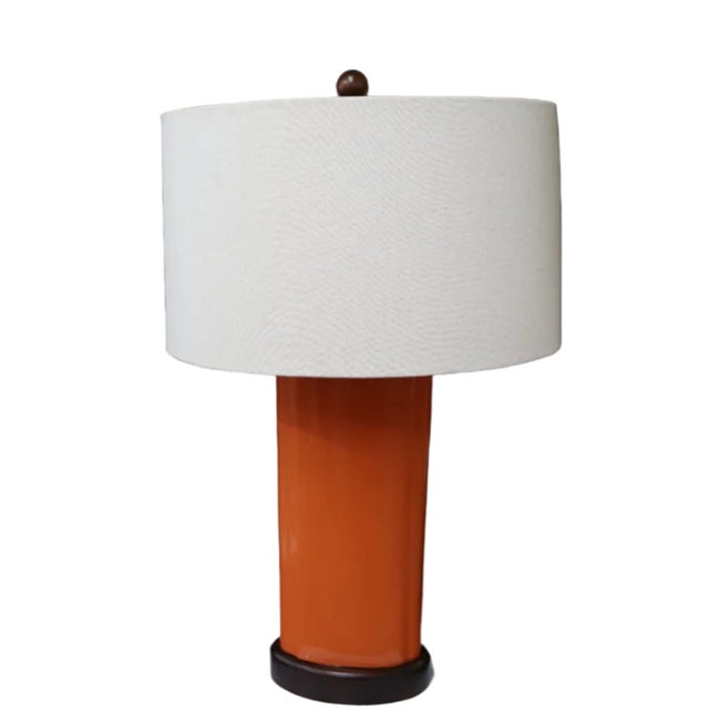 With an oblong pumpkin glazed ceramic body atop a wooden base, this charmingly vibrant MCM style table lamp by Robert...