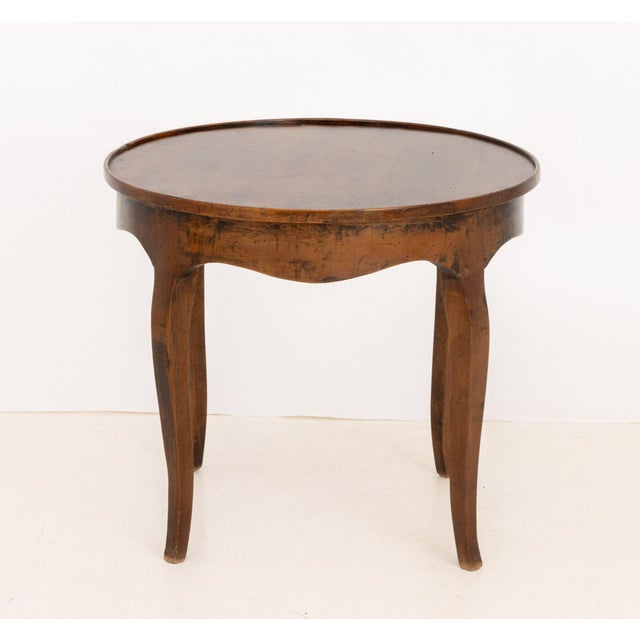 Italian Circular Walnut Occasional Table, on four cabriole legs, marked "Made in Italy" to underside. 22.25" H x 26"...