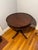 An elegant and beautifully crafted mahogany drum top parlor table, featuring a classic circular form with a continuous...