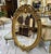 Elegant French-style oval wall mirror featuring an exquisitely hand-carved wooden frame with intricate floral and scroll...