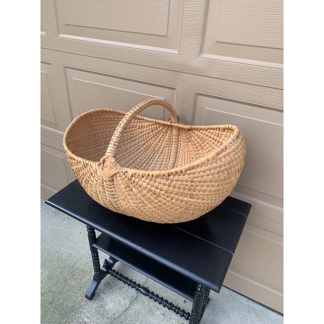 A large American splint oak gathering basket with woven twig handle. The charming basket has a tight weave and would be...