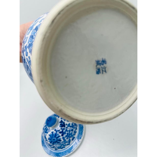 This beautiful piece is a blue and white porcelain ginger jar with a lid, featuring intricate hand-painted designs. The...