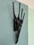 This sculpture is a Brutalist-style wall sconce, crafted from wrought iron between the 1960s and 1970s. The Brutalist...
