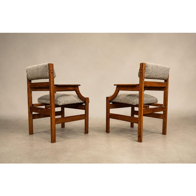 A sculptural pair of Brazilian Modern armchairs crafted in richly figured Caviúna hardwood, these exceptional 1960s...