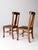 Pair of 1930s oak splat back side chairs with carved claw feet and black faux leather seats. The tall backs and shaped...