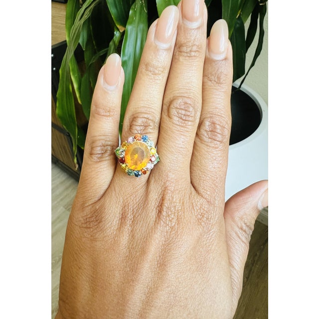 6.74 Carat Fire Opal, Sapphire, Emerald, and Diamond Cocktail Ring This exquisite ring showcases a stunning 3.60 carat...
